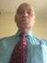 A person wearing a tie and a blue shirt

Description automatically generated